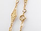 an image of a pair of gold plated earrings on a white surface