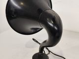 an old fashioned black phonom on a white table