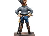 statue of a man in a cowboy outfit holding a gun