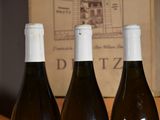 three bottles of wine that are sitting on a table