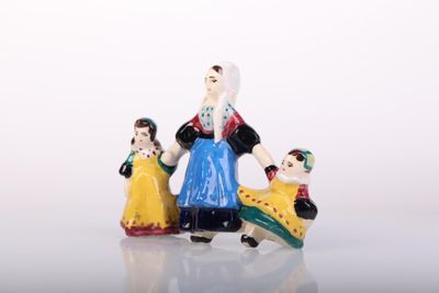 three figurines of a woman, a man and a child