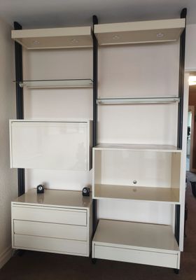 a white bookcase with two drawers in the corner