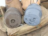 two old gas masks sitting on top of a pile of bags