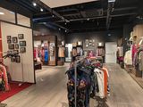 an image of a clothing store with clothes on display