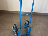 a blue hand truck that is sitting on the floor