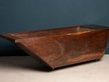 an old wooden bath tub sitting on top of a cement floor