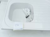 a white sink with a white faucet and a white faucet