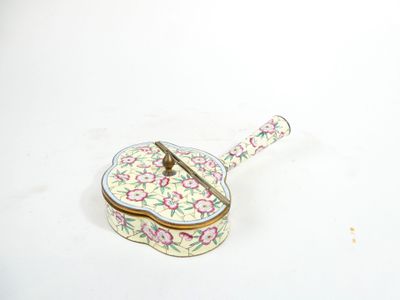 a small box with a spoon sitting on top of it