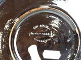 a close up of a black plate with a white sticker on it