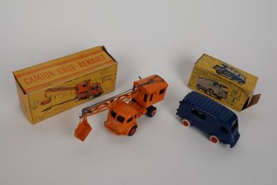 three toy trucks are sitting next to each other on a white surface