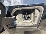 a close up of a car ' s front bumper with an electrical outlet