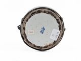 a white plate with a blue flower on it