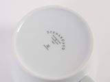 a close up of a coffee cup on a white surface
