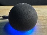 an image of a smart device sitting on top of a wooden table