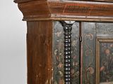 an old wooden cabinet with a floral design on it