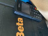 a cell phone that is sitting on top of a laptop