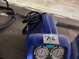 a blue machine that is sitting on top of a table