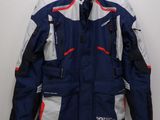 a close up of a jacket on a hanger on a wall