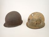 two helmets are sitting next to each other on a white surface