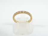 a yellow gold ring with diamonds on a white background