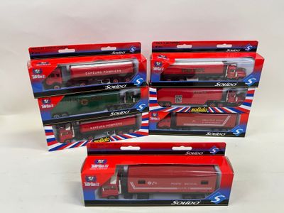 three boxed red and green toy trains sitting on top of each other