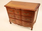 a small wooden chest of drawers on a white background