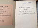 a book with a handwritten page on it sitting on a table