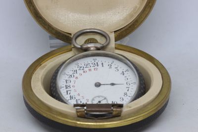 a pocket watch inside of a case on a white surface