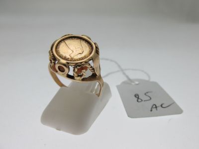 a gold ring with a coin on it and a price tag