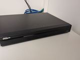 a black dvd player sitting on a white table