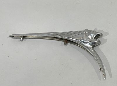 a silver metal object on a white surface
