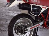 a red and white motorcycle parked in a garage