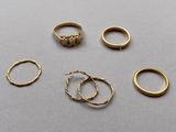 several gold rings and rings are arranged on a gray surface