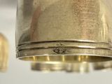 a silver bell hanging from a ceiling with two bells