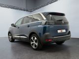the rear view of a blue car parked in a garage