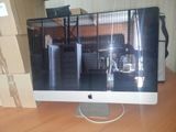a computer monitor sitting on top of a wooden desk