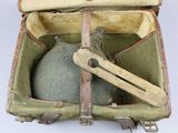 an old suitcase with a metal object inside of it