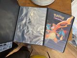 a person sitting at a table with a pokemon game in front of them