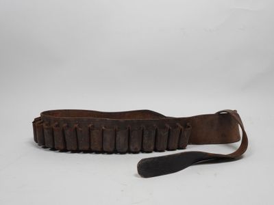 an old leather belt with a knife on a white background