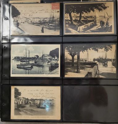 many pictures of boats on display on the wall