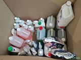 a cardboard box filled with different types of bottles and containers