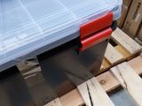a plastic tool box sitting on a pallet in a warehouse