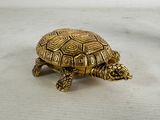 gold turtle figurine on a white background