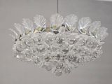 a glass chandelier hanging from a ceiling in a room