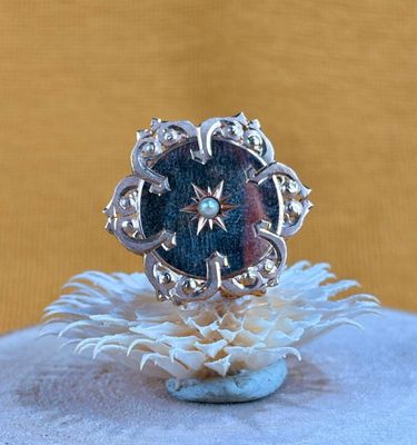 sterling silver ring with a blue stone center surrounded by white flowers