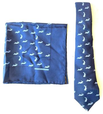 a blue tie and a blue pocket square on a table