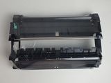a close up of a black printer unit on a white surface