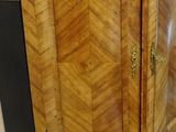 a wooden cabinet with a marble top on a tile floor