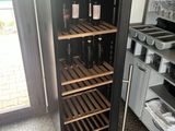 a refrigerator that has many bottles of wine inside of it