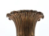 a close up of a black and gold vase on a white background